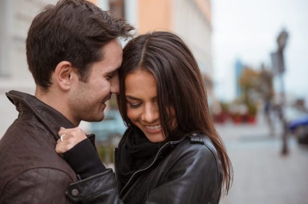 portrait-of-a-smiling-young-couple-hugging-outdoors-SBI-301036182 (1)